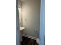 Stylish powder room featuring a pedestal sink, modern fixtures, and elegant flooring at 5552 Stafford Rd # 28, Charlotte, NC 28215