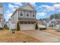 Two-story house with gray siding, brick accents, and a two-car garage at 612 Spencer Ln, Kannapolis, NC 28081