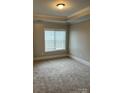 Bedroom with neutral carpet, a large window, and tray ceiling at 6605 Central Pacific Ave, Charlotte, NC 28210