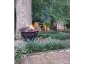 Charming backyard fire pit area with brick pavers and lush greenery at 8149 Mattingridge Dr, Charlotte, NC 28270