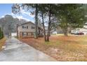 A charming two-story home with a spacious front yard and mature trees at 939 Malotte Ln, Gastonia, NC 28054