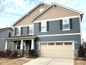 Beautiful home featuring blue siding, stone accents, and a welcoming front porch at 9831 Quercus Ln, Huntersville, NC 28078