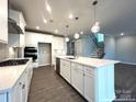 Bright kitchen features white cabinetry, an island, and stainless steel appliances at 9831 Quercus Ln, Huntersville, NC 28078