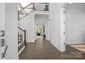 Bright entryway with hardwood floors, staircase, and views to living room at 11112 Benjamin Smith Ave, Huntersville, NC 28078