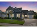 Two-story home with gray siding, stone accents, and a landscaped yard at 11112 Benjamin Smith Ave, Huntersville, NC 28078