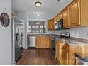 Modern kitchen with stainless steel appliances and wood cabinets at 121 Beverly Chase Ln, Mooresville, NC 28117