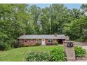 Traditional brick ranch-style home with a manicured lawn and classic architectural details at 132 30Th Nw Ave, Hickory, NC 28601
