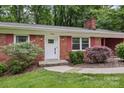 Close up of a brick home showcasing the front door and well-maintained landscaping at 132 30Th Nw Ave, Hickory, NC 28601
