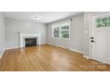 Bright living room with hardwood floors, a cozy fireplace, and natural light at 132 30Th Nw Ave, Hickory, NC 28601
