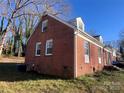 Side view of brick house, nicely landscaped at 1916 Elmwood Dr, Gastonia, NC 28054