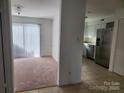 Bright dining area with carpet flooring and access to the kitchen at 3508 Colony Rd # H, Charlotte, NC 28211