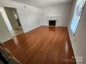 Spacious living room featuring hardwood floors and a fireplace at 3508 Colony Rd # H, Charlotte, NC 28211