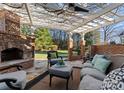 Outdoor patio with fireplace and seating area under a pergola at 5401 Sunningdale Dr, Charlotte, NC 28277