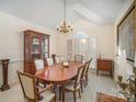 Formal dining room with wood table and chairs, and large window at 5550 Monticello Nw Dr, Concord, NC 28027