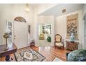 Bright entryway with hardwood floors and views into the living room at 5550 Monticello Nw Dr, Concord, NC 28027