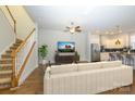 Inviting living room showcasing a staircase, media center, and an open view to the kitchen at 7542 Waverly Walk Ave # 7542, Charlotte, NC 28277