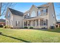 Two-story house with brown shutters and a large front yard at 9729 Capella Nw Ave, Concord, NC 28027