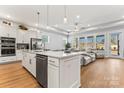 Modern kitchen with island, stainless steel appliances, and white cabinets at 1025 Lake Como Dr, Monroe, NC 28110