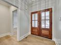 Elegant foyer with double glass doors, light walls, and luxury vinyl plank flooring at 1037 Oakmont Dr, Rock Hill, SC 29732