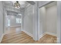 Bright hallway featuring coffered ceilings, white trim, and luxury vinyl plank flooring at 1037 Oakmont Dr, Rock Hill, SC 29732