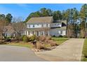 Two-story home with charming front porch, landscaped yard, and long driveway at 116 Cedar Branch Ct, Mooresville, NC 28117