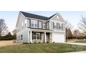 Inviting two-story house with gray siding, a covered porch, and an attached two-car garage at 1305 39Th Avenue Ne Pl, Hickory, NC 28601