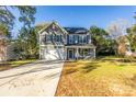 Two-story house with gray siding, blue shutters, and a large front yard at 1305 39Th Avenue Nw Pl, Hickory, NC 28601