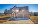 Two-story home with gray siding, two-car garage, and a covered porch at 187 Lone Pine Rd, Statesville, NC 28625