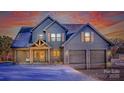 Two-story farmhouse with gray siding, two-car garage, and covered porch at dusk in the snow at 187 Lone Pine Rd, Statesville, NC 28625