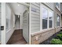 A light and bright townhouse entryway featuring an open door, hardwood floors, and a staircase leading to the upper level at 2013 Federation Ct, Charlotte, NC 28205