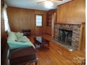 Living room with fireplace, hardwood floors and built-in shelving at 211 Walnut Ave, Mount Holly, NC 28120