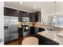 Stainless steel appliances and dark brown cabinets in kitchen at 2430 Kensington Station Pkwy, Charlotte, NC 28210