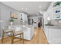 Modern kitchen with white cabinets, granite countertops, and stainless steel appliances at 3065 River Bend Dr, Tega Cay, SC 29708