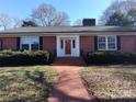 Brick Ranch with a red door and well-manicured lawn at 352 7Th Nw St, Hickory, NC 28601