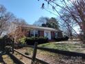 Brick home with a wood fence and spacious yard at 352 7Th Nw St, Hickory, NC 28601