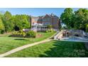 Expansive backyard featuring a patio, landscaped garden beds, and a walkway leading to the pool at 4165 54Th Ne Ave, Hickory, NC 28601