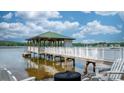 Dock on the lake with a covered structure and Adirondack chairs for relaxing by the water at 4165 54Th Ne Ave, Hickory, NC 28601