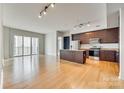 Open living space with hardwood floors and kitchen island at 4620 Piedmont Row Dr # 509, Charlotte, NC 28210