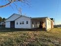 White vinyl siding addition with covered patio at 648 Scotts Creek Rd, Statesville, NC 28625