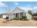 Gray house with white accents, front porch, and landscaping at 8715 Pennegrove Cir, Charlotte, NC 28214