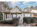 Tan house with white door, landscaping, and black shutters at 9325 Four Mile Creek Rd, Charlotte, NC 28277