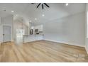 Open living room with vaulted ceiling, hardwood floors, and kitchen island at 936 Jackson Rd, Fort Lawn, SC 29714