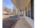 Inviting front porch with brick flooring and a porch swing at 1013 Ashwood Pl, Salisbury, NC 28146