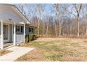 Front porch and side yard of a house at 102 Hickory St, Locust, NC 28097