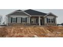 New gray house with stone accents, two-car garage, and landscaping at 104 Kerr Walk Dr # 14, Statesville, NC 28677