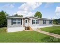 Gray mobile home with stone accents and a small front porch at 114 River Ridge Ln, Hickory, NC 28601