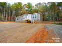 Gray mobile home on a hillside with stairs and wooded surroundings at 114 River Ridge Ln, Hickory, NC 28601