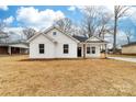 Charming white home with dark trim, manicured lawn, and inviting front porch at 1200-1 Stanton Dr, Shelby, NC