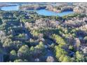 Aerial view showcasing a house and lakefront property at 121 Sierra Woods Dr, Troutman, NC 28166