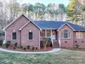 Brick house with a gray roof, walkway, and landscaping at 121 Sierra Woods Dr, Troutman, NC 28166